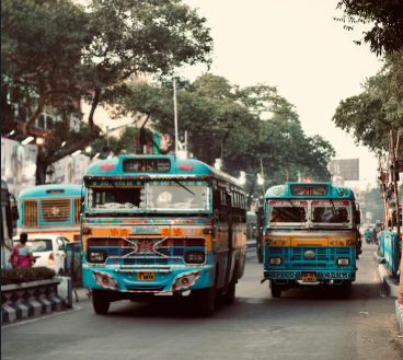 Colorful buses on Delhi road Public transport in New Delhi Delhi city street with buses Traffic scene in Delhi Local buses in Delhi city Transport in New Delhi Busy Delhi road with buses Vehicles on Delhi street Daily travel in Delhi Delhi transport system buses