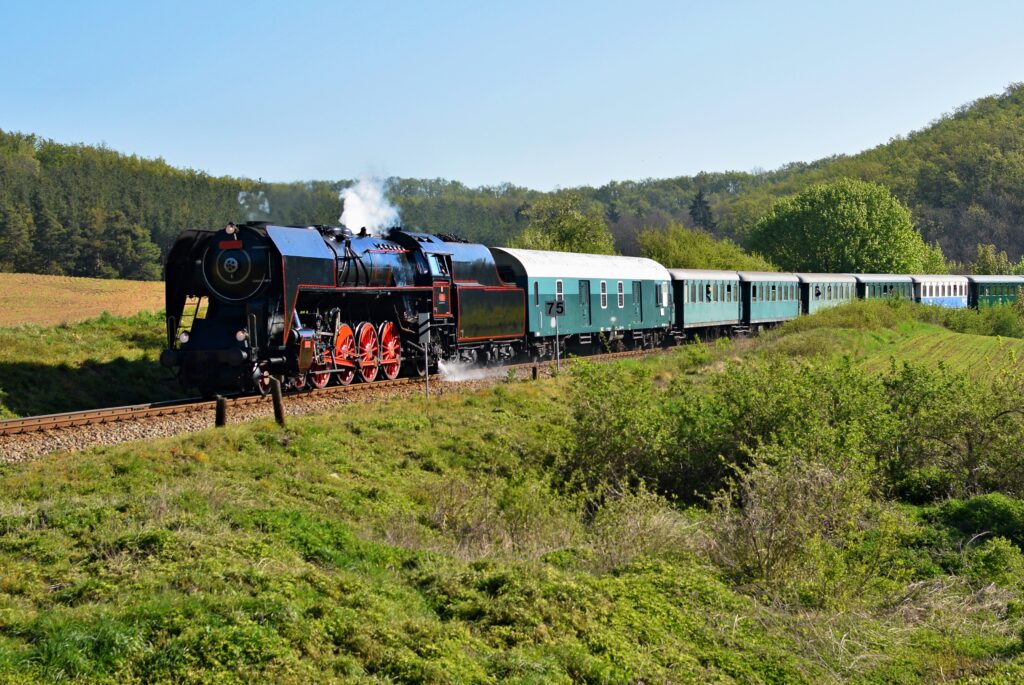 steam train valley, summer green hills, scenic train route, vintage train travel, countryside railway track, nature and travel, Indian rail journey, summer holiday India, train through valley, green landscape India