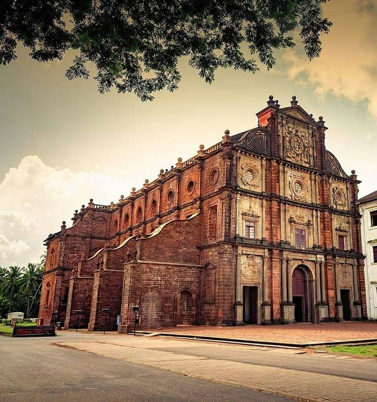 Basilica of Bom Jesus Old Goa Church Heritage Red Laterite Architecture Goa UNESCO Site Baroque Church India Historic Building Goa 16th Century Church Ancient Christian Site Colonial Goa Church Dramatic Sky Church