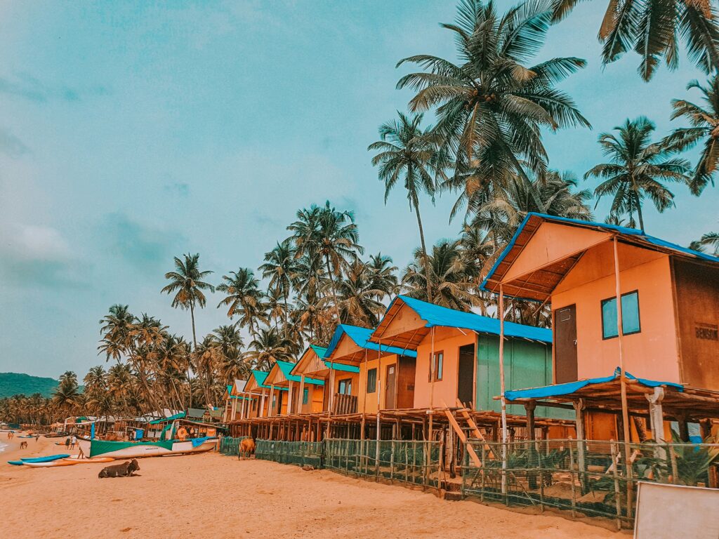 Colorful Beach Huts Tropical Beach Resort Goa Beach Shacks Palm Trees Beach Huts Beachfront Accommodation Sandy Beach Cottages Vibrant Seaside Huts India Beach Travel Stilt Huts Ocean View Holiday Beach Cabins