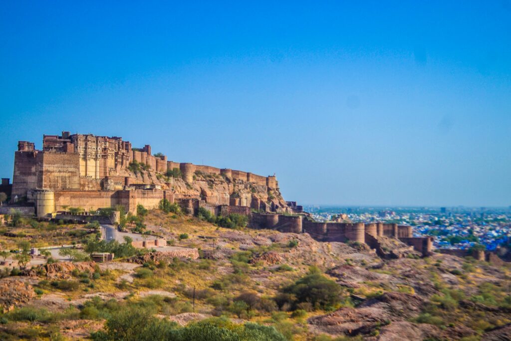 mehrangarh fort jodhpur rajasthan panoramic view historic indian fort on hill travel jodhpur blue city skyline from fort massive sandstone walls heritage site makm photography rajasthan fort ancient indian architecture tourist spot rajasthan desert landscape fort exterior fortification walls high angle view historical landmarks india clear sky jodhpur mehrangarh cityscape backdrop
